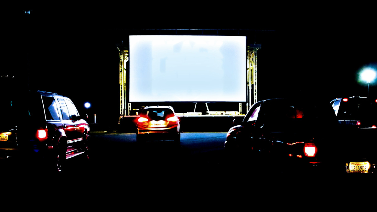people in their cars attending a drive-in movie screening